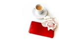 Coffee cup with coffee, cell phone in a red leather case, and a dusty rose Royalty Free Stock Photo