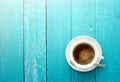 Top view of coffee cup on a ocean blue wood table background wit
