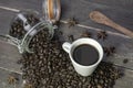 Top view coffee cup with roasted coffee beans in glass jar on rustic wooden table Royalty Free Stock Photo