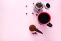 coffee cup, spoon of ground coffee beans and jar with coffee beans on a pink background Royalty Free Stock Photo