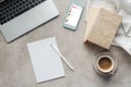 top view of coffee with laptop and smartphone with music player app on screen on concrete surface