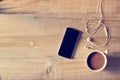 Top view of coffee, mobile phone on a wooden background