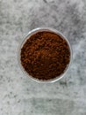 Top view of coffee powder in glass bowl with defocused background