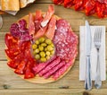 Top view of coldcuts of jamon, sausages on wooden board Royalty Free Stock Photo