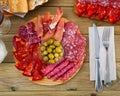 Top view of coldcuts of jamon, sausages on wooden board Royalty Free Stock Photo