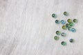 Top view of collection of shiny marbles on wooden background