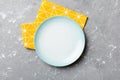 Top view on colored background empty round blue plate on tablecloth for food. Empty dish on napkin with space for your Royalty Free Stock Photo