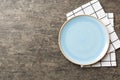 Top view on colored background empty round blue plate on tablecloth for food. Empty dish on napkin with space for your Royalty Free Stock Photo