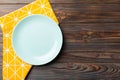 Top view on colored background empty round blue plate on tablecloth for food. Empty dish on napkin with space for your design Royalty Free Stock Photo