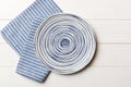 Top view on colored background empty round blue plate on tablecloth for food. Empty dish on napkin with space for your Royalty Free Stock Photo