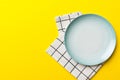 Top view on colored background empty round blue plate on tablecloth for food. Empty dish on napkin with space for your Royalty Free Stock Photo