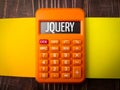 Top view colored notebook and calculator with text JQUERY Royalty Free Stock Photo