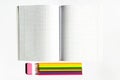 Top view Colored pencils eraser and checkered notebook on white paper Royalty Free Stock Photo