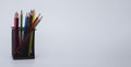 Colored wooden pencils in black metal glass on white background. text space. banner Royalty Free Stock Photo