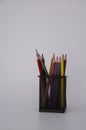 Colored wooden pencils in black metal glass on white background. text space. banner Royalty Free Stock Photo