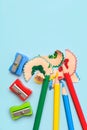 Top view of colored pencils, pencil sharpener and pencil shavings with space for text. Back to school concept Royalty Free Stock Photo