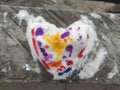 Top view  of colored snow heart on the wood made by child. Backdrop for Valentines day card. Royalty Free Stock Photo