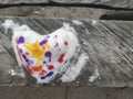 Top view  of colored snow heart on the wood made by child. Backdrop for Valentines day card with copy space. Royalty Free Stock Photo