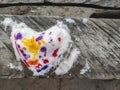 Top view  of colored snow heart on the wood made by child. Backdrop for Valentines day card with copy space. Royalty Free Stock Photo