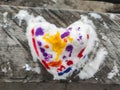 Top view  of colored snow heart on the wood made by child. Backdrop for Valentines day card. Royalty Free Stock Photo