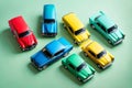 Top view of colored toys cars on pastel green background. Flat lay style on pastel green background