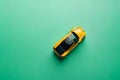 Top view of colored toys cars on pastel green background. Flat lay style on pastel green background. Copyspaces.