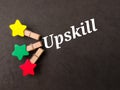 Top view colored wooden clips with text Upskill