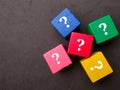 Top view of colored wooden cubes with question icons Royalty Free Stock Photo