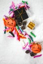 Top view of colorful candies and decorative candy bags in shape of Halloween pumpkins Royalty Free Stock Photo