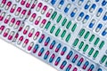 Top view of colorful capsule pills in blister pack arranged with beautiful pattern. Pharmaceutical packaging. Medicine for infecti