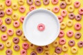 Top view of colorful cereal rings and a bowl of milk