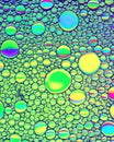 Top view on colorful drops of oil on the water. Circles and ovals