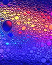 Top view on colorful drops of oil on the water. Circles and ovals