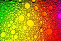 Top view on a colorful drops of oil on the water. Rainbow or spectrum colored circles, ovals Royalty Free Stock Photo