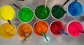 Top view, colorful fabric printing inks in white buckets.