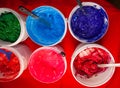Top view, colorful fabric printing inks in white buckets. Royalty Free Stock Photo
