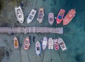 A top view of colorful fishing boats anchoring in marina next to jetty wooden pier Royalty Free Stock Photo