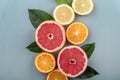 Top view of colorful fruit slices with citrus leaf arrangement. Summer tropical juice concept with lemon, grapefruit and orange on Royalty Free Stock Photo