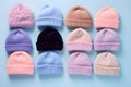 Top view of colorful knitted winter hats on blue background