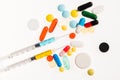 Top view of colorful medical pills and syringes on white Royalty Free Stock Photo