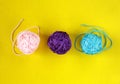 Top view of colorful nylon thread balls on yellow background. Concept of individuality