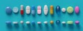 Top view of colorful pills, tablets and capsules on light blue colored background Royalty Free Stock Photo