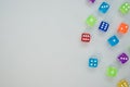 Top view of colorful plastic dice on a gray background with space for text