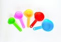 Top view colorful of plastic measuring spoons set in blue sky, red, orange, violet and green on white background. Utiles used to Royalty Free Stock Photo