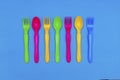 Top view of colorful spoon and fork element on blue color table.flat lay design