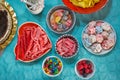 Top view of colorful sweets on birthday tableTop view of colorful sweets on birthday table with blue tablecloth