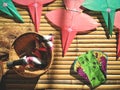 Top view of colorful Thai traditional snake and star-shaped kites with loincloth and rope in bamboo basket on wooden litter