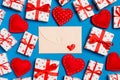 Top view of colorful valentine background made of craft envelope, gift boxes and red textile hearts. Valentine`s Day concept Royalty Free Stock Photo