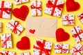 Top view of colorful valentine background made of craft envelope, gift boxes and red textile hearts. Valentine`s Day concept Royalty Free Stock Photo