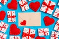 Top view of colorful valentine background made of craft envelope, gift boxes and red textile hearts. Valentine`s Day concept Royalty Free Stock Photo